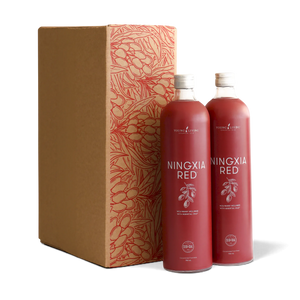 Two NingXia Red bottles beside a patterned gift carton