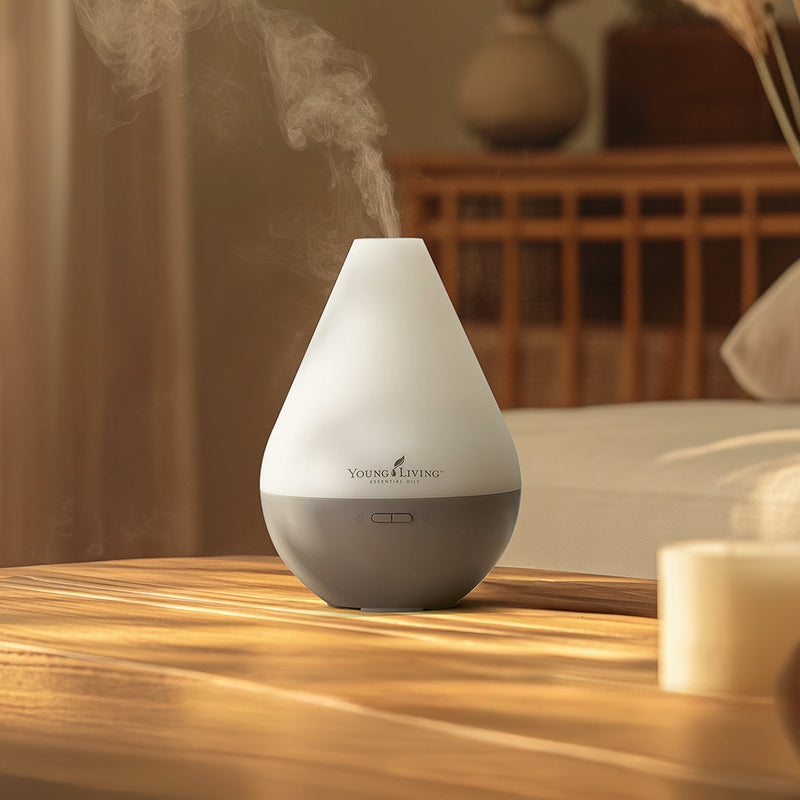 A person holding up a cordless Young Living diffuser